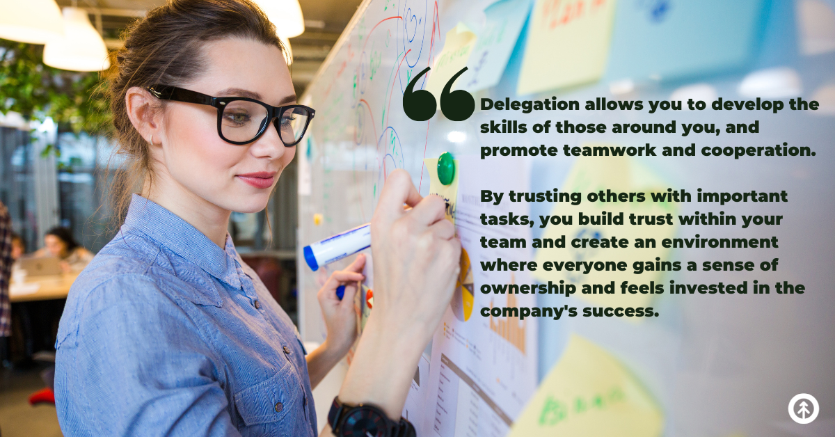 A business leader writing notes to their team on a whiteboard with a quote about the benefits of delegation from Growth Marketing Firm. 
