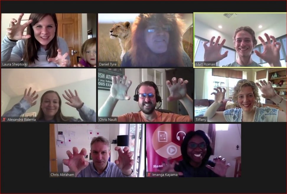 A screenshot of eight people on a Google Meet call with their hands making claws like a lion with Growth Marketing Firm founder Chris Nault at center and Dan Tyre wearing a lion costume at top center. 