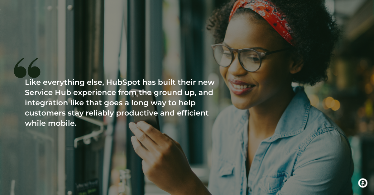 A happy customer service representative works in a coffee shop on their mobile device with a quote from Growth Marketing Firm about HubSpot’s update to Service Hub mobile features.