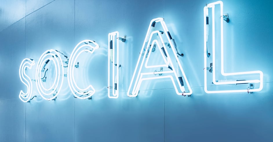 A blue neon sign of the word social on a light blue background