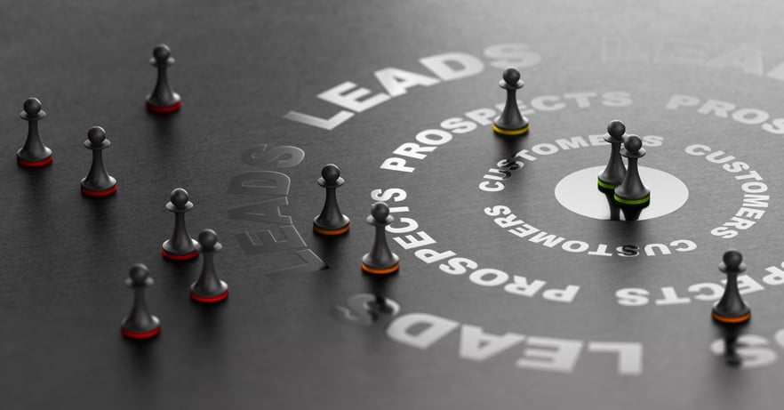 Game pieces scattered strategically around a black board with the word Leads printed in a circle to represent lead generation 